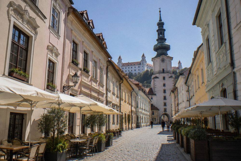 Pastel-colored baroque facades on a narrow street in the Bratislava Old Town