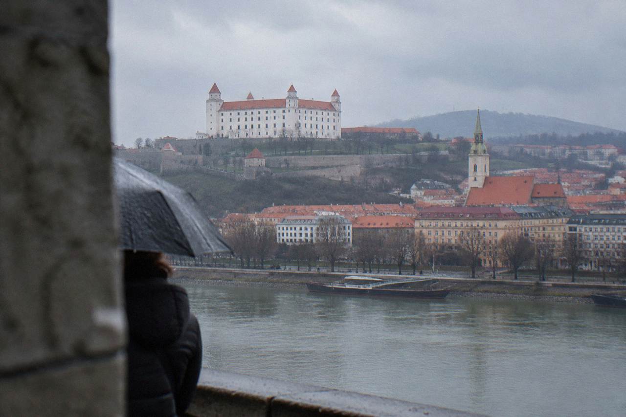 Bratislava Castle standing above the Danube river with the city rooftops spread below it