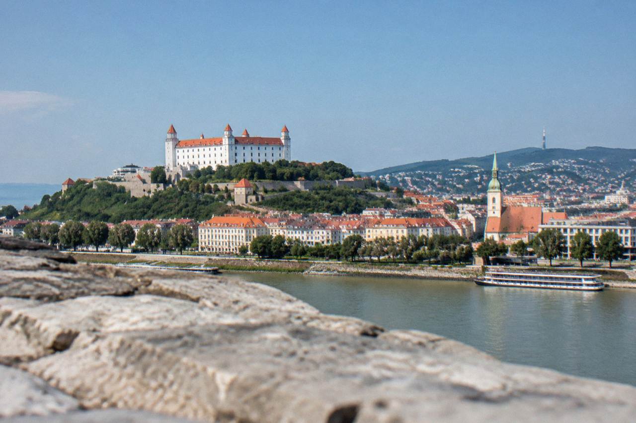 Bratislava Castle standing above the Danube river and the city rooftops on a clear day