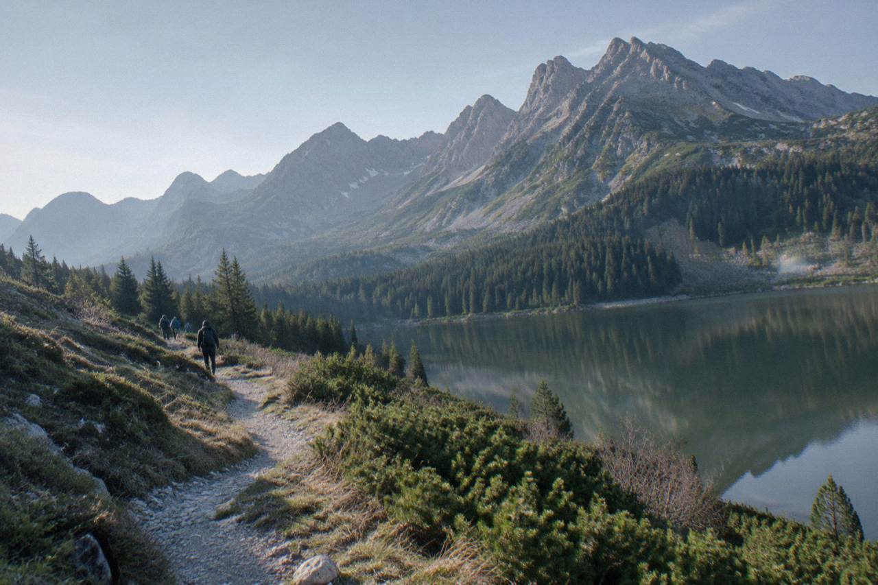 Mountain peaks of the High Tatras rising above a green valley with a winding footpath