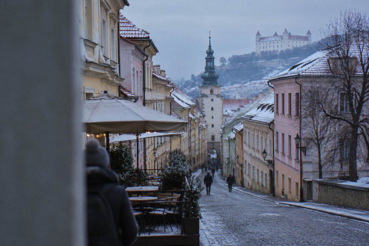 Snow-dusted rooftops of the Bratislava Old Town seen from near the castle hill in winter