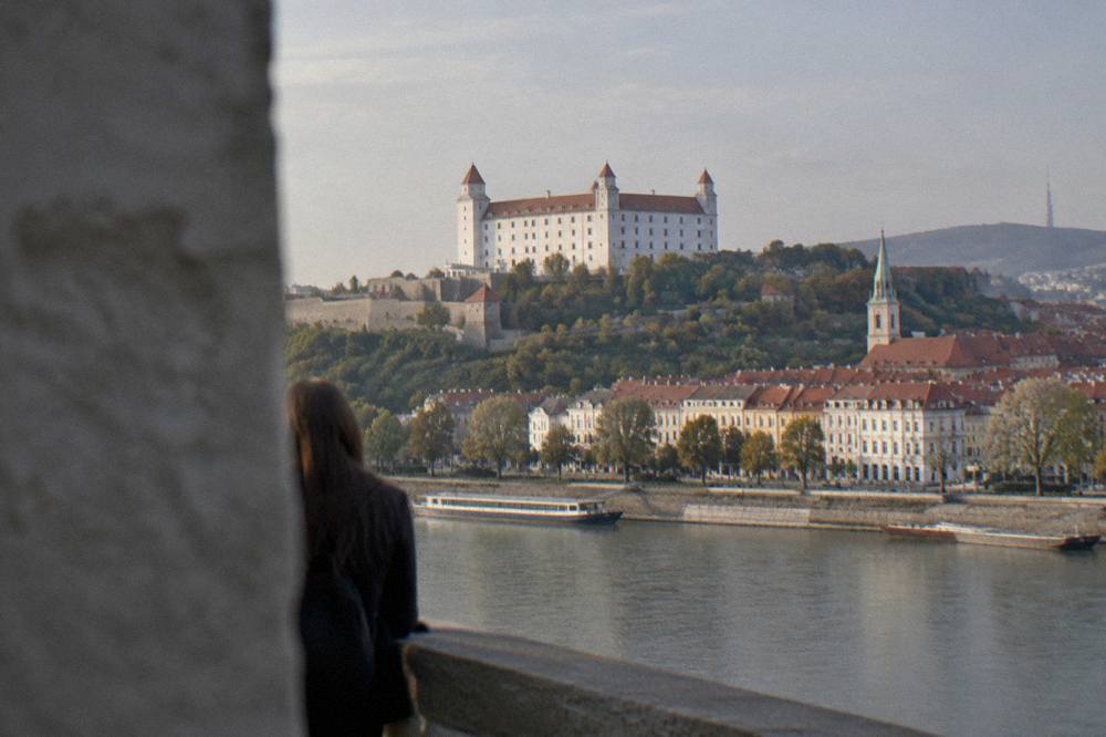 Bratislava Castle standing above the Danube riverfront at dusk