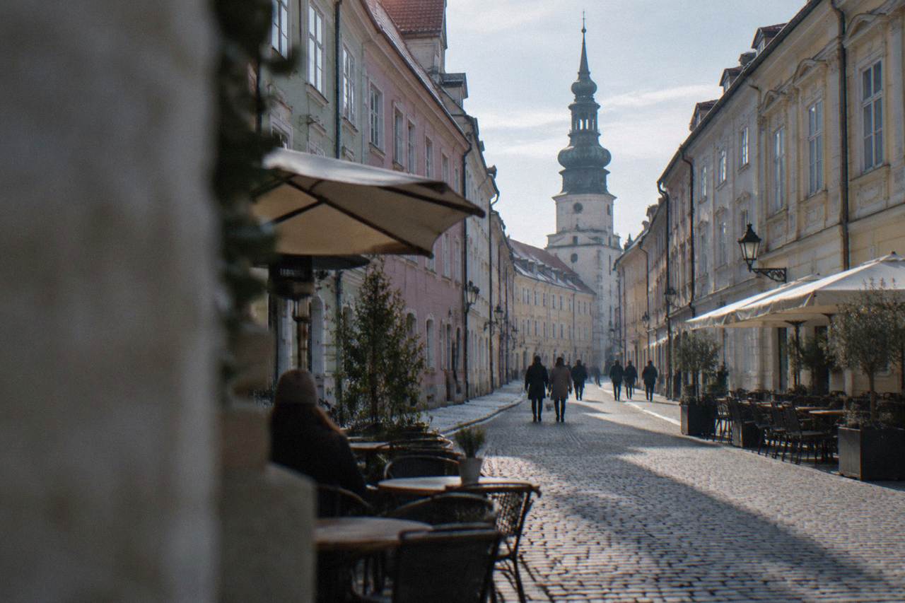 Pastel colored historic buildings on a pedestrian square in the Bratislava Old Town