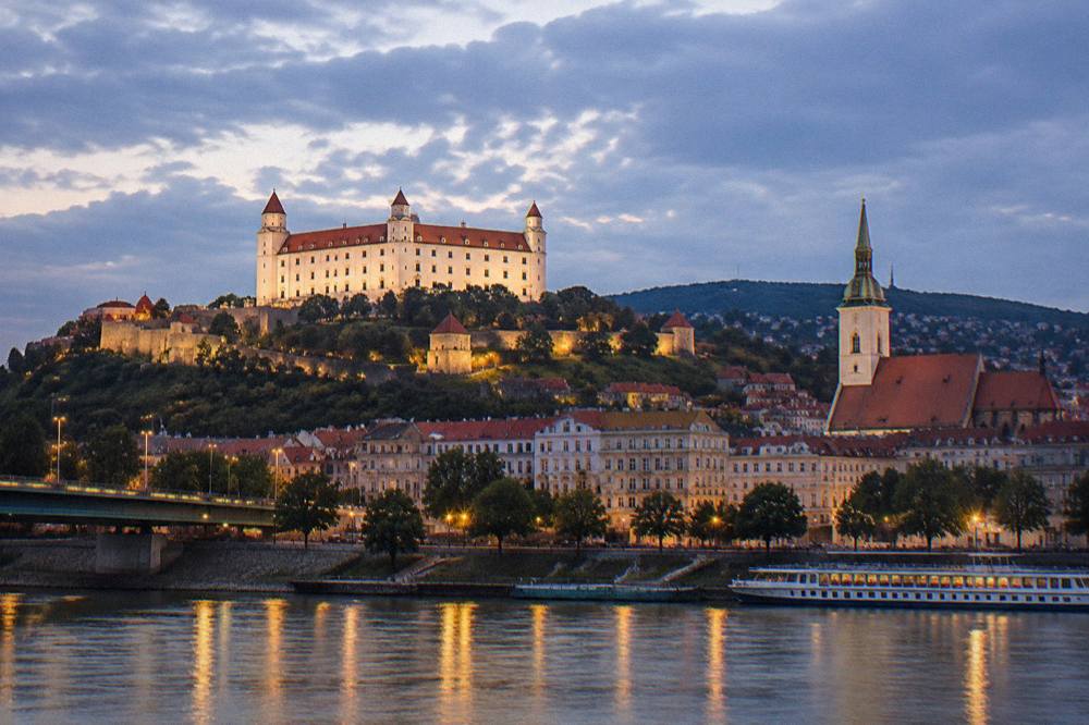 Bratislava Castle illuminated at night above the city skyline