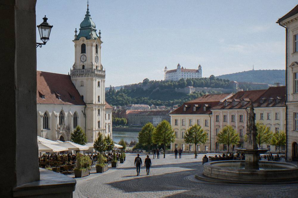 A wide view over Bratislava rooftops toward the castle on the hill