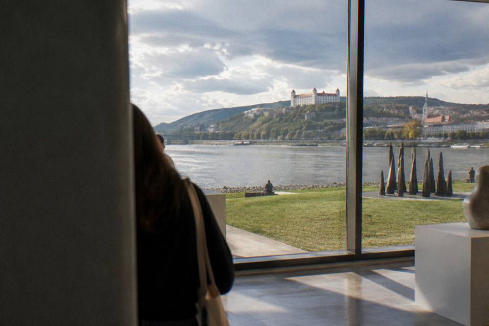 Sunlit gallery window with a view across the water