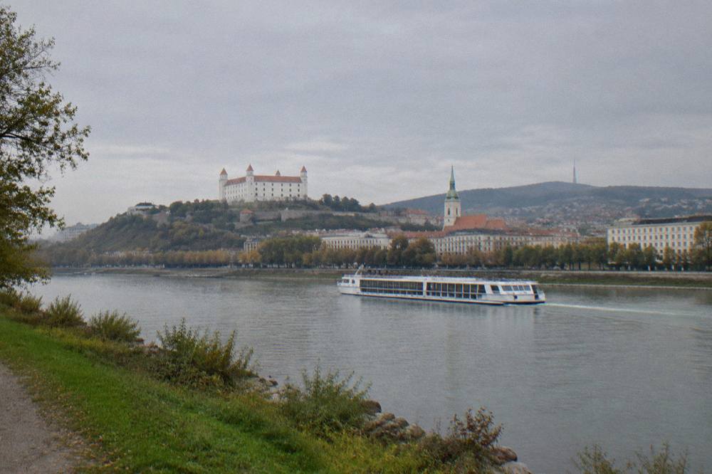 A riverboat on the Danube seen from a green riverbank near Bratislava