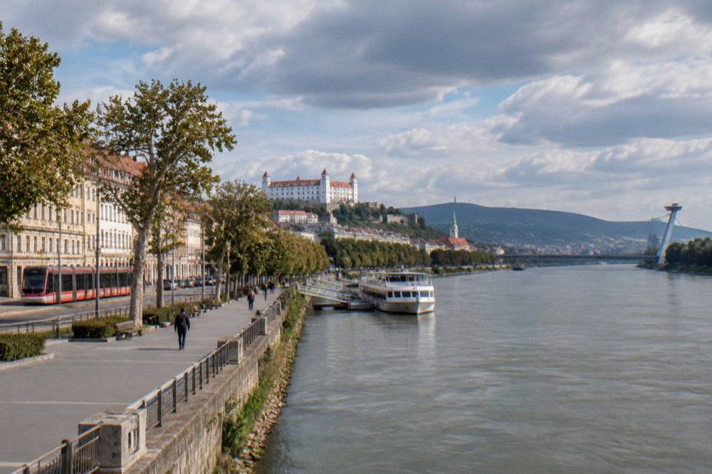A tram moving along a street in central Bratislava near the riverfront