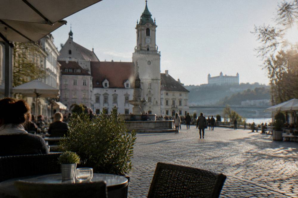 A cafe terrace beside a modern shopping street near the Danube in Bratislava