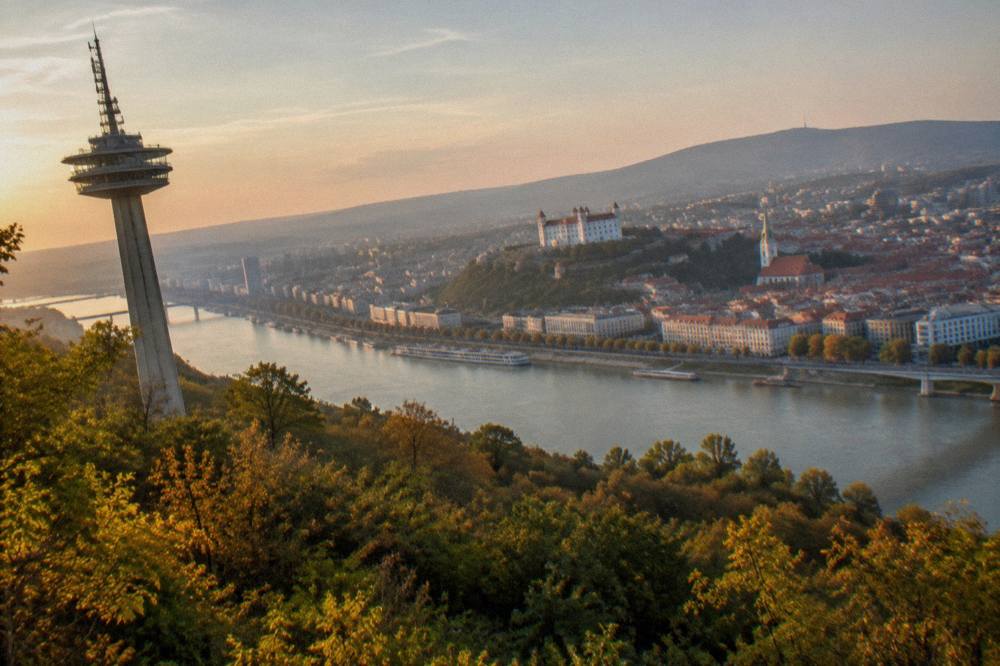 A city skyline seen from a high vantage point with a river running through it