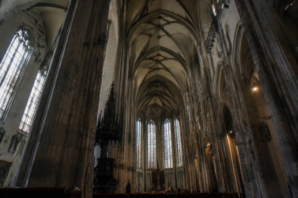 Interior of a Gothic church with tall stone columns and vaulted ceiling