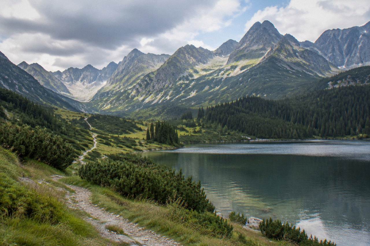 Mountain peaks of the High Tatras rising above a green valley with a winding path