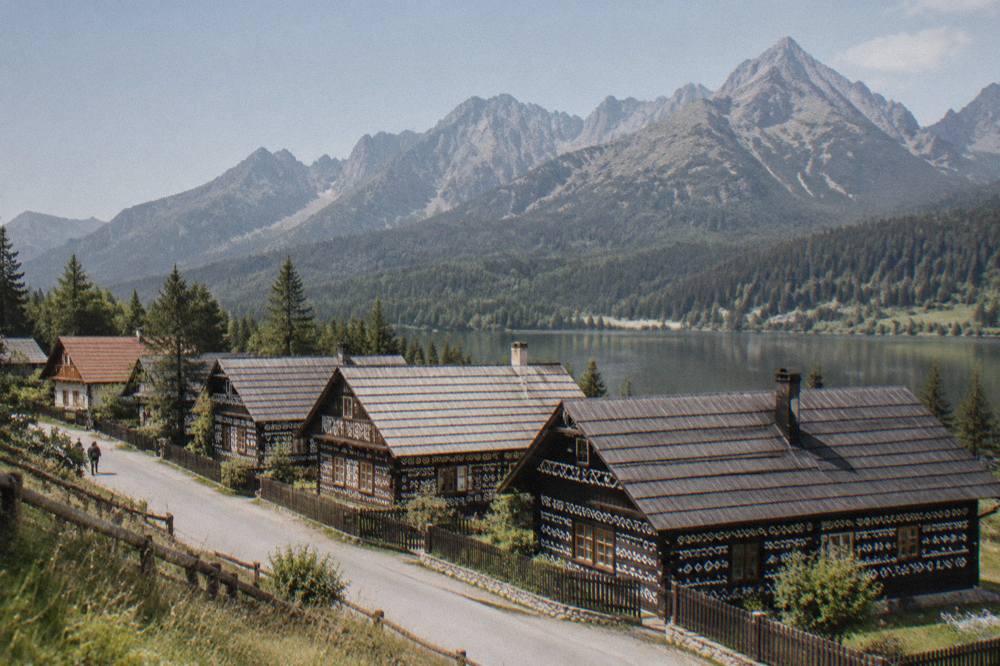 A row of traditional wooden houses decorated with white painted geometric patterns