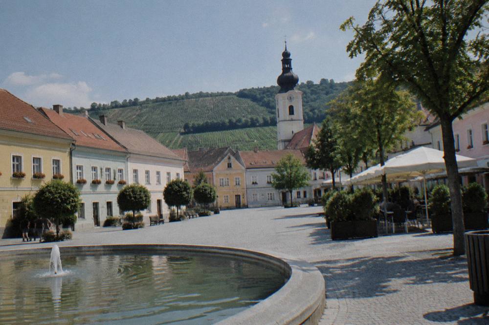 A town square with colourful facades and a church tower