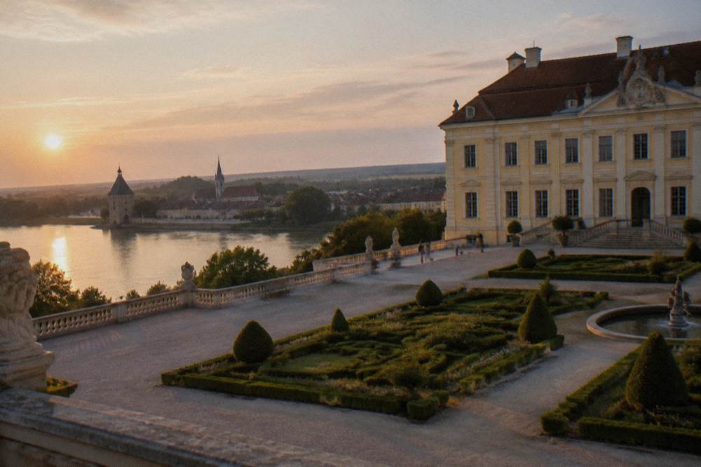 A river town with a fortified gate tower and church spires along the Danube