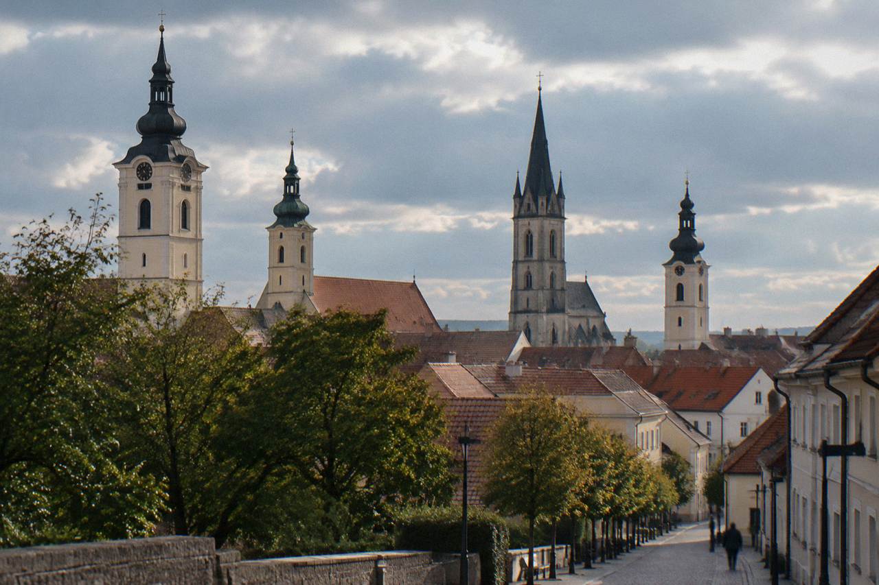 A row of church towers rising above the rooftops of a small Slovak town