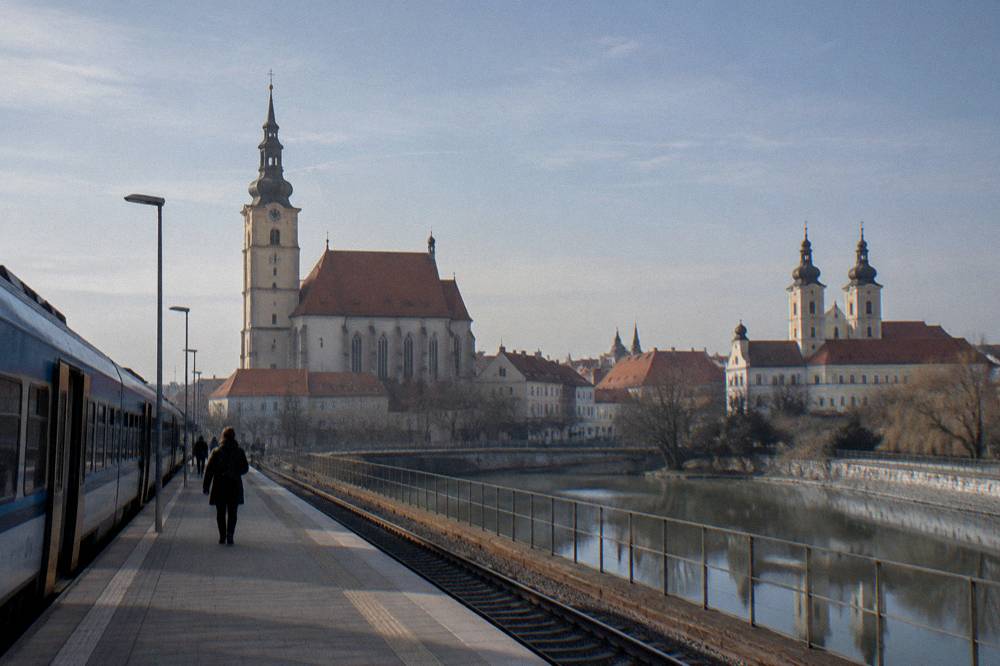 Regional train standing at a Slovak station platform in morning light