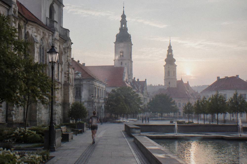Evening light on a town square with illuminated church spires