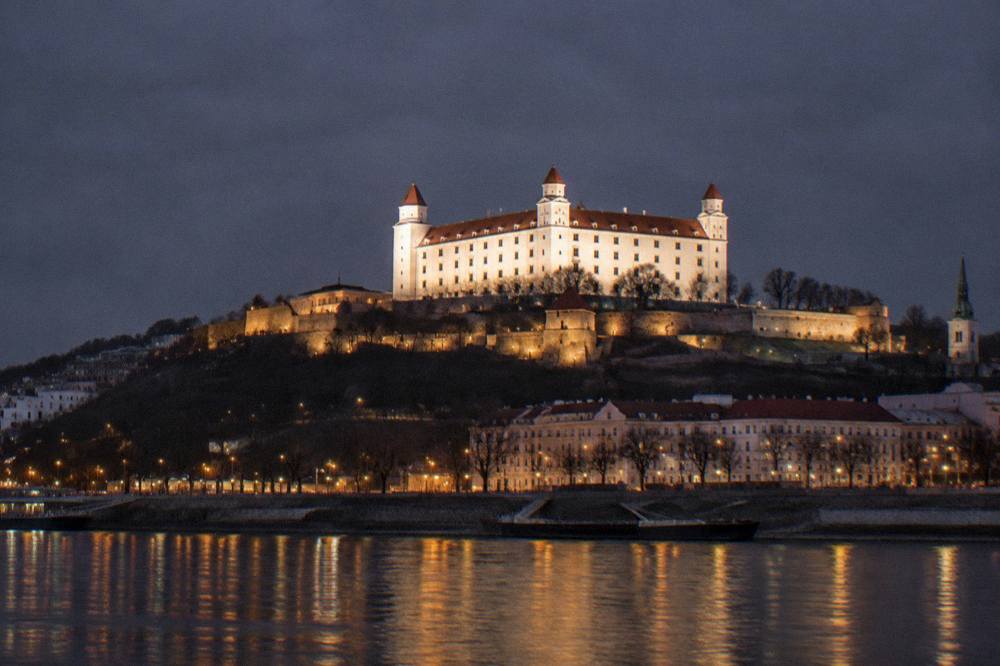 Illuminated Bratislava castle on the hill above the Danube at night