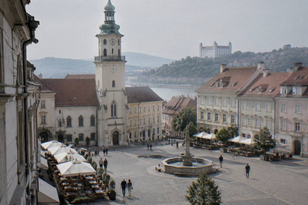 A lane of restaurant tables and chairs along a street in central Bratislava