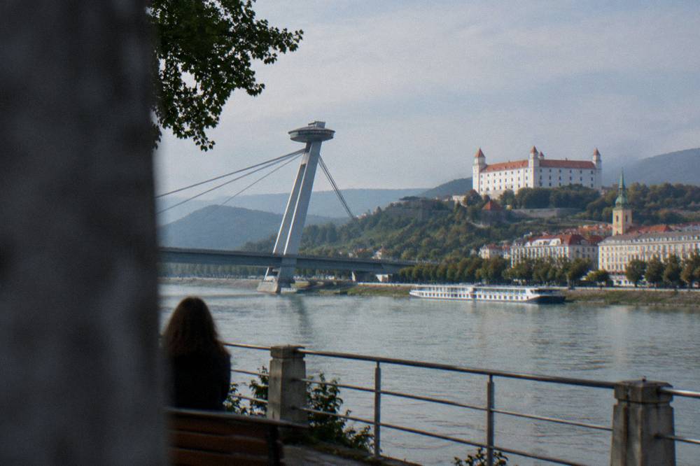 The Danube riverfront in Bratislava with the UFO observation deck on the bridge above