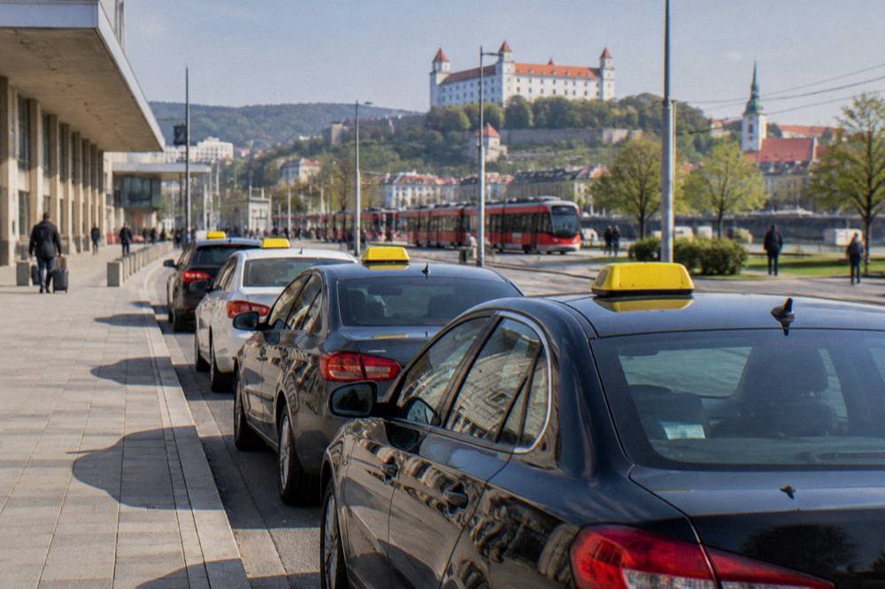A row of taxis waiting in a pickup lane outside a terminal