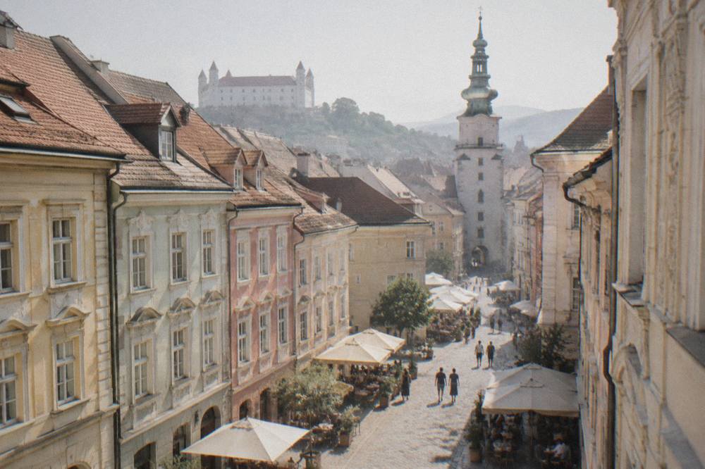 Pastel facades and cafe tables on the pedestrian Main Square in Bratislava old town