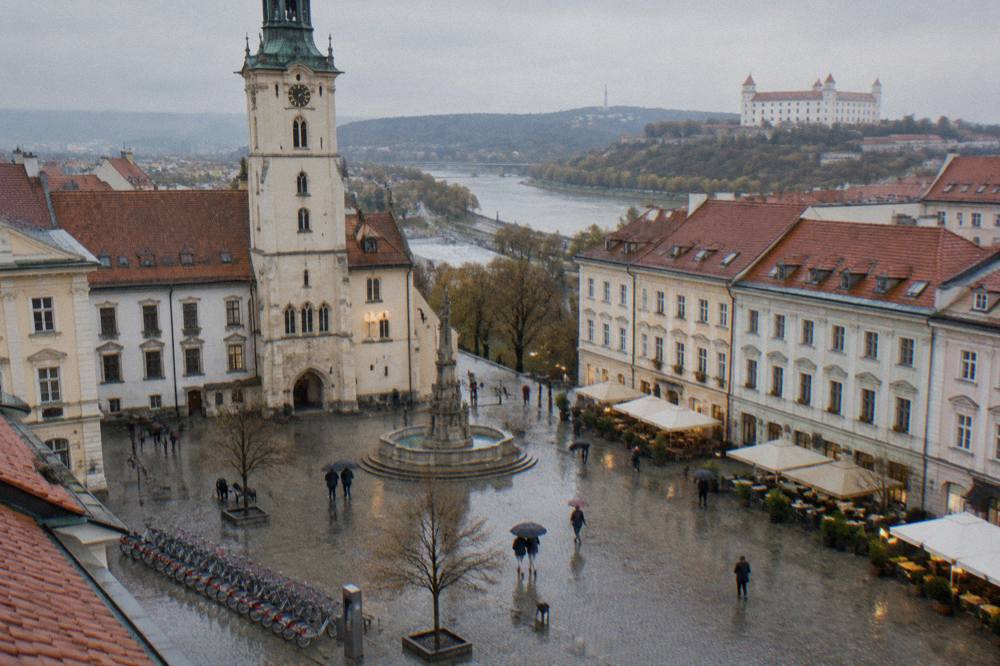 A row of shared rental bikes docked at a station on a Bratislava street