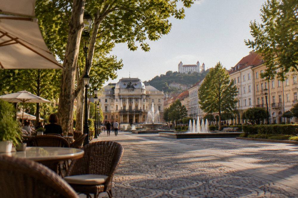Outdoor café tables on a square in warm evening light