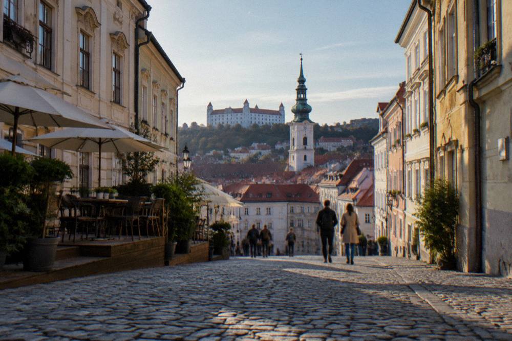 Visitors walking with a view over the red roofs of the Bratislava Old Town