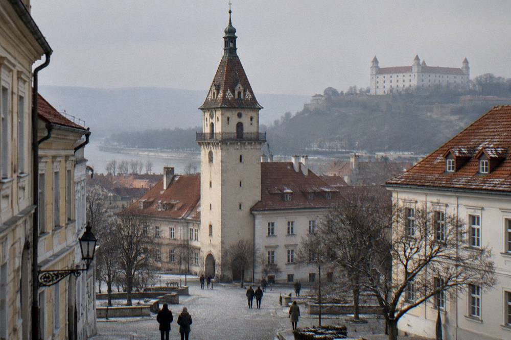 The Old Town Hall tower above rooftops with winter light in Bratislava