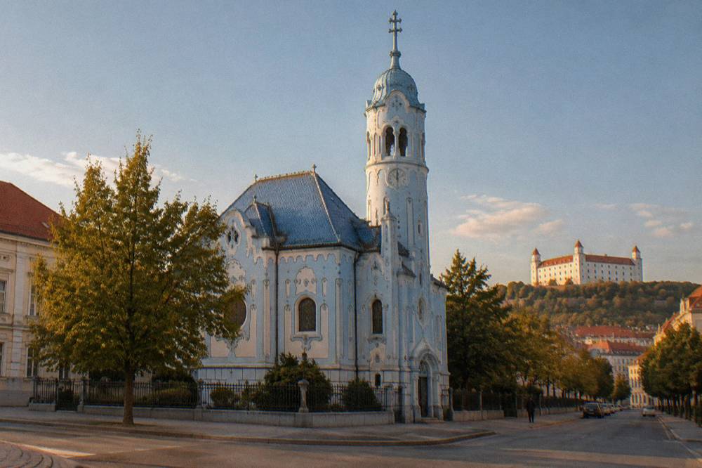 Pale blue church facade with ornate detailing seen from a quiet street