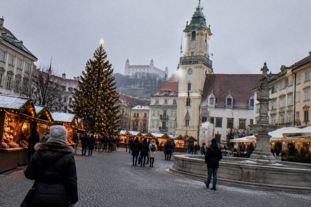 The Christmas market stalls and illuminated tree on Main Square in Bratislava at dusk