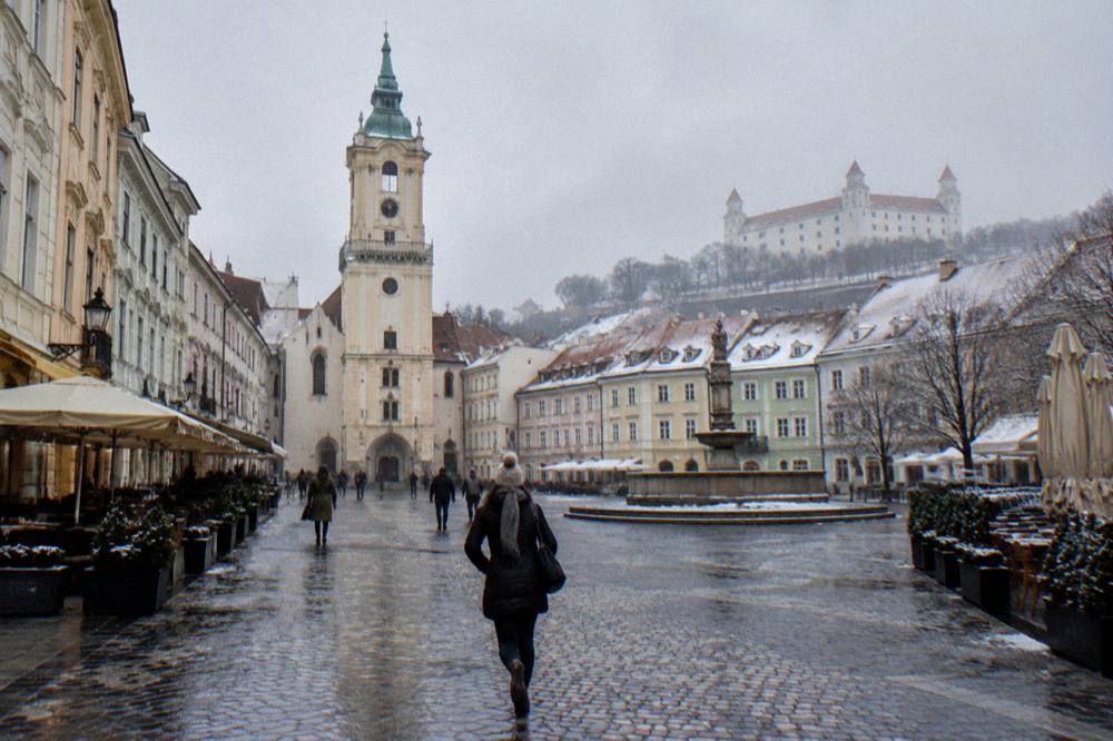 Snow-dusted roofs of a Slovak castle town under a winter sky