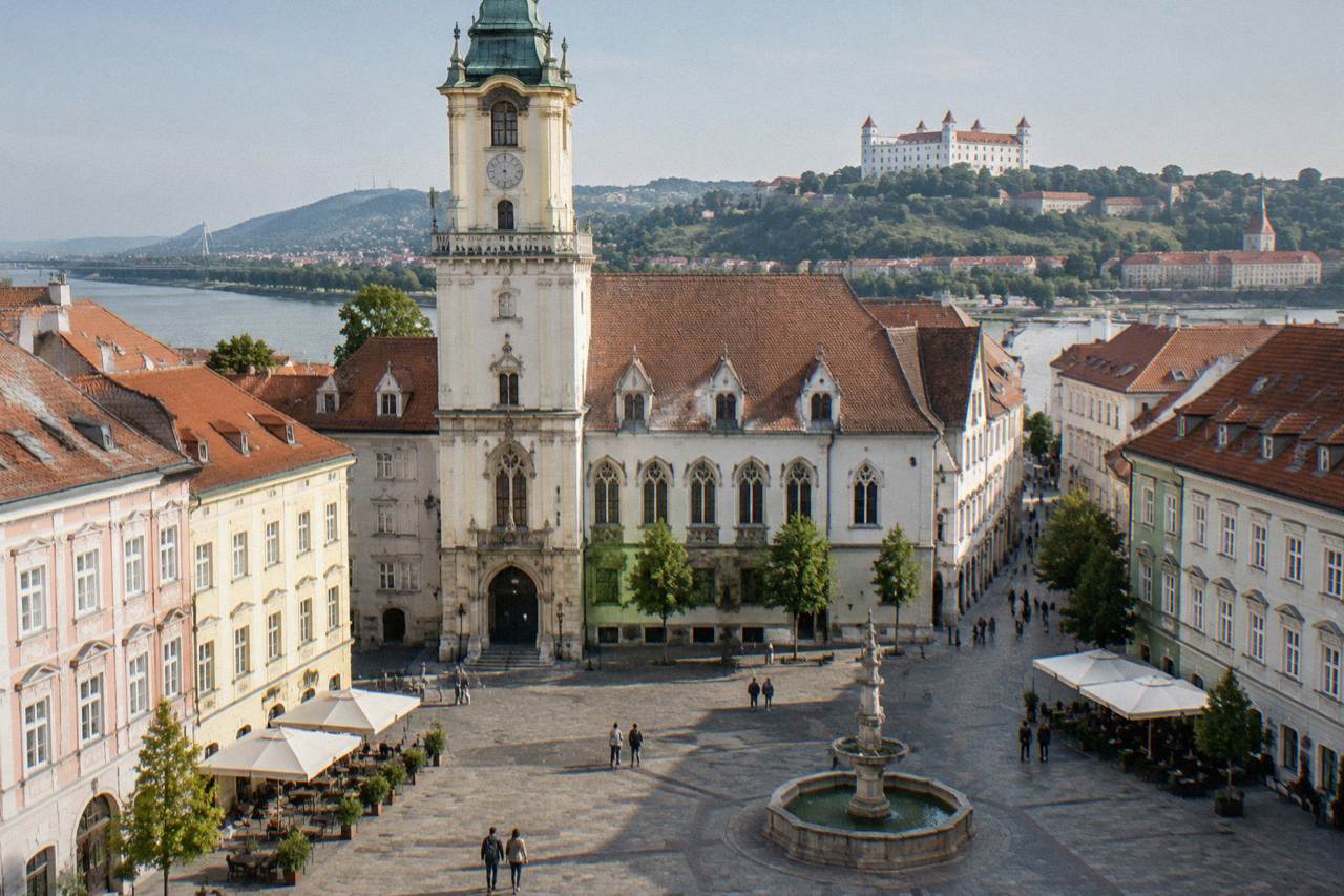 Historic building facade on a Bratislava square with a museum entrance below a tower