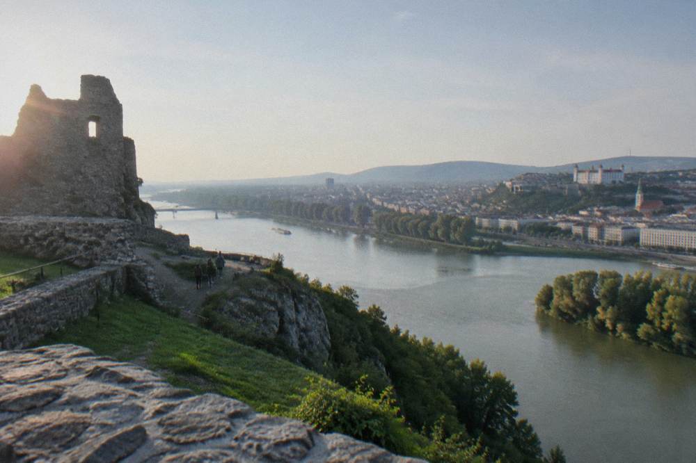 Stone walls and green grounds of Devin Castle above two rivers meeting