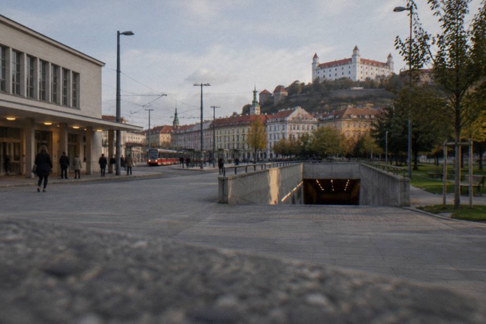 Entrance ramp to an underground car garage near a hilltop castle