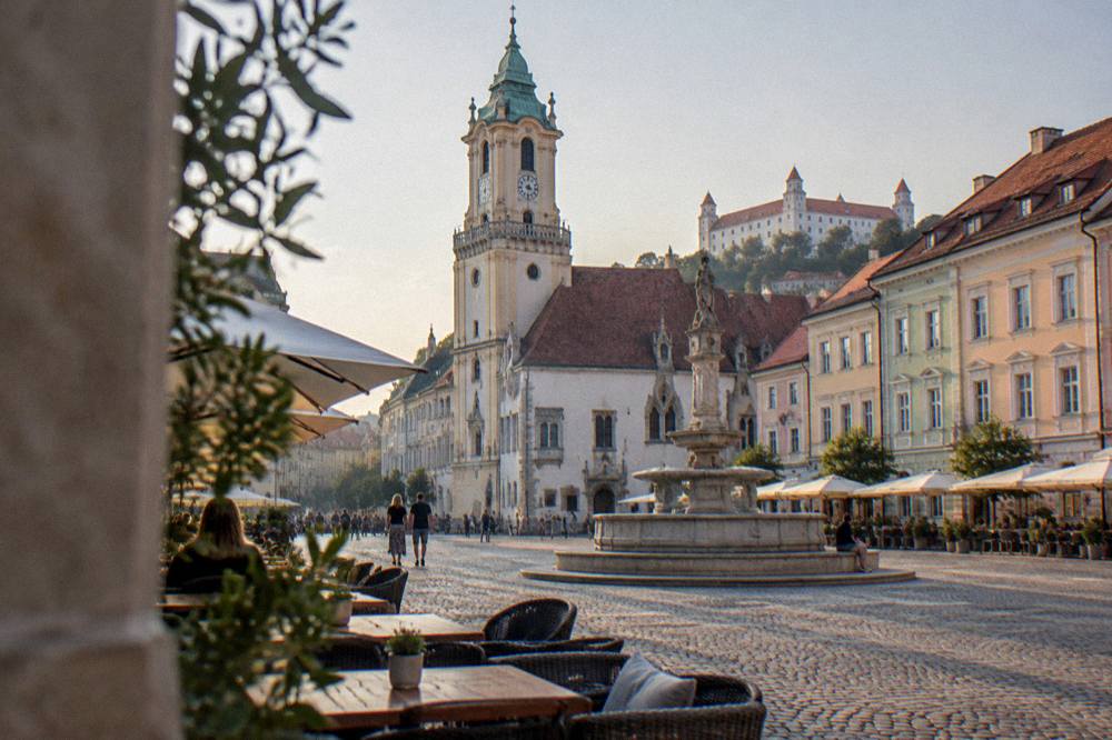 Evening light on Hlavné námestie square in Bratislava with cafe tables and colourful facades