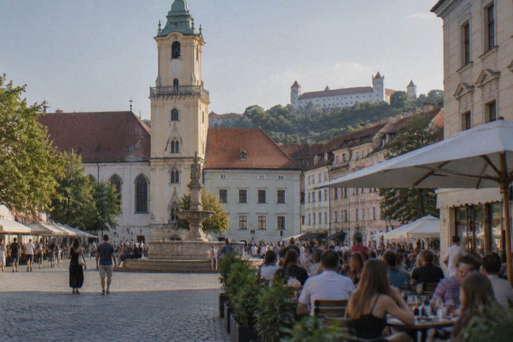 Evening crowds at a bar terrace on a Bratislava square