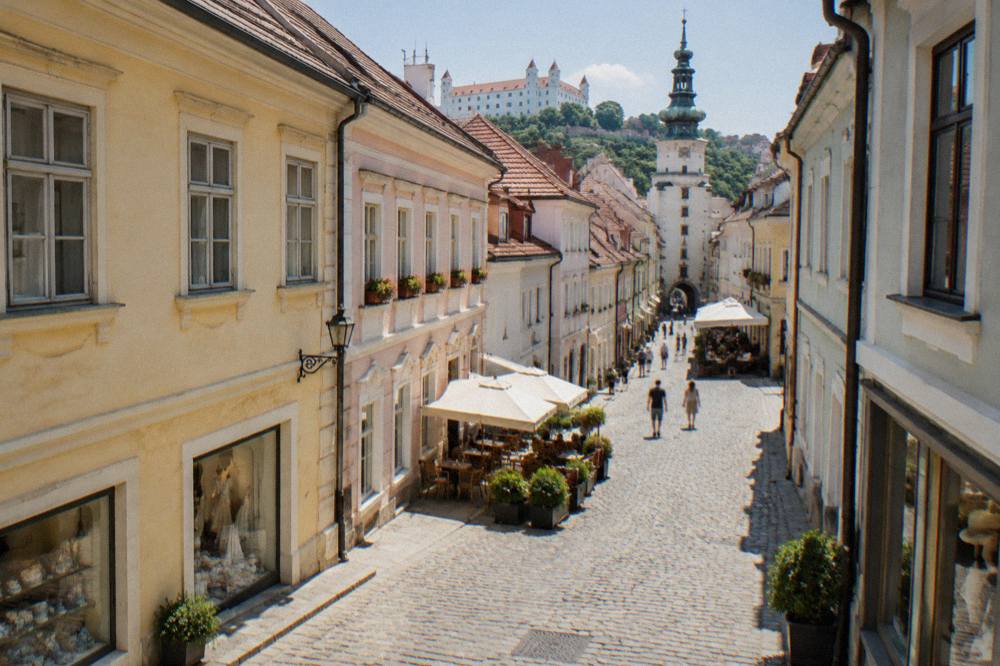 Shop windows and a cobbled lane in Bratislava Old Town during daytime