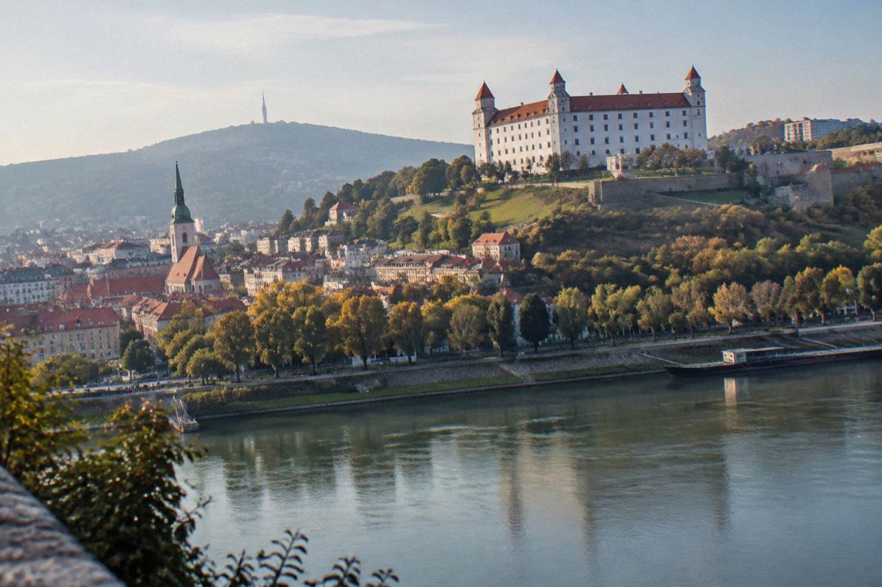 Bratislava Castle standing above the Danube river with the Old Town rooftops below