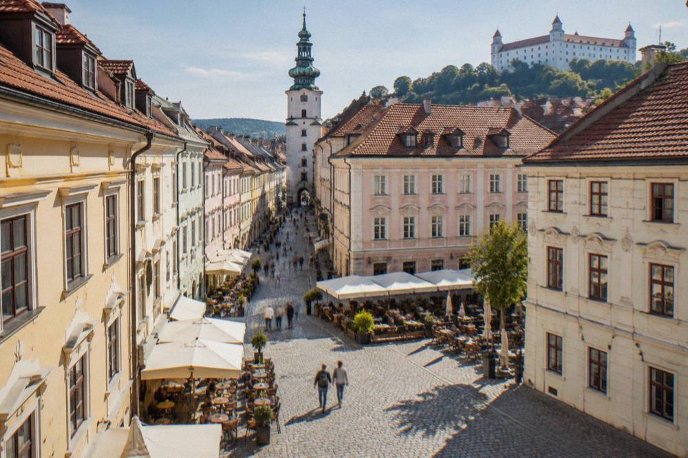 The Main Square in Bratislava Old Town with pastel coloured burgher houses and outdoor tables