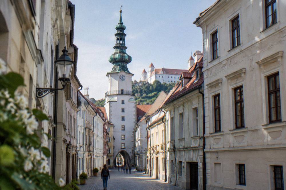 Michael's Gate tower rising over a narrow Old Town street in Bratislava