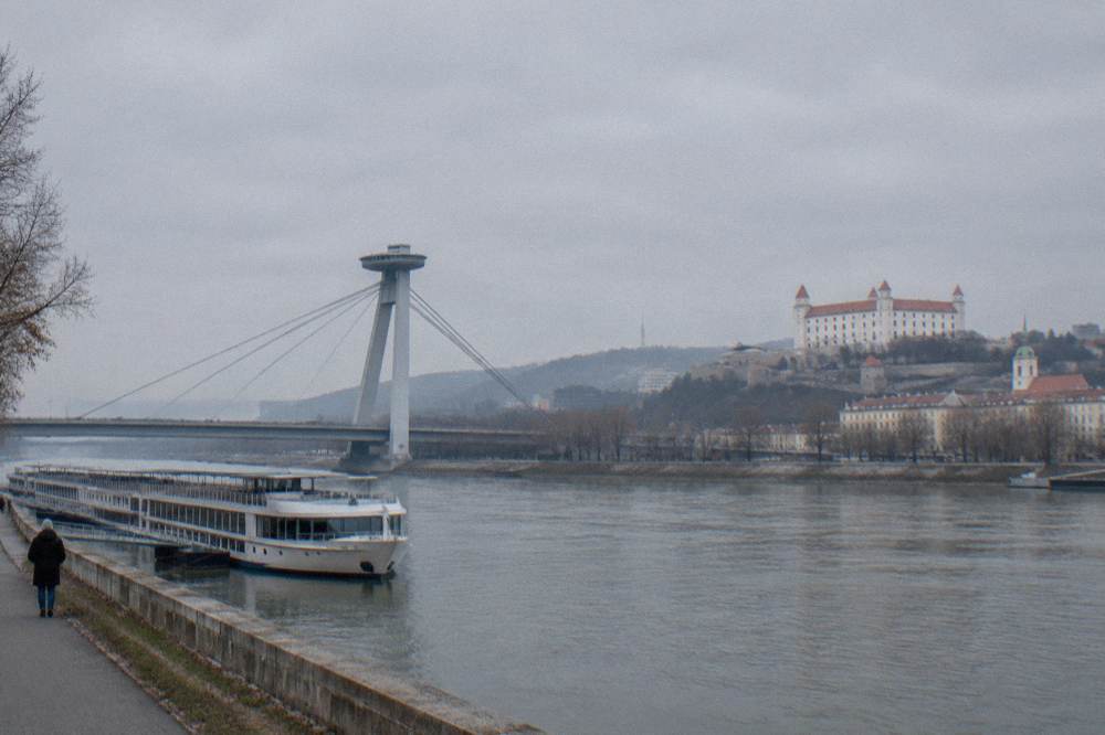 A Danube river cruise boat moored near the UFO bridge in Bratislava