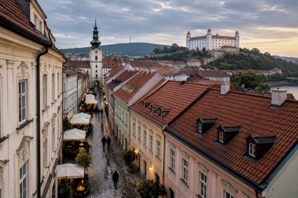 Evening view over red rooftops of the old town towards the castle on the hill