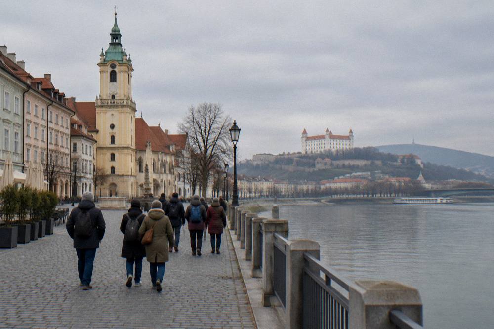 A tour group walking beside the Danube embankment in Bratislava