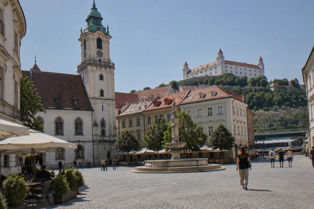 A regional train pulling into Bratislava main station under a clear sky
