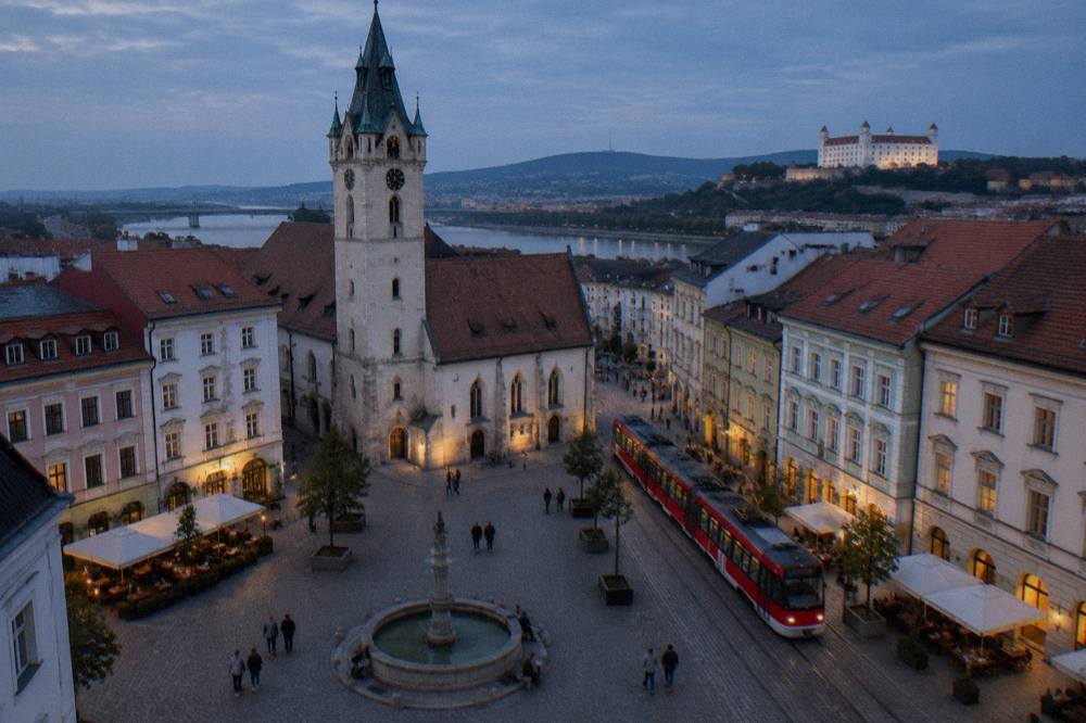 A tram moving along a street in central Bratislava with passengers aboard