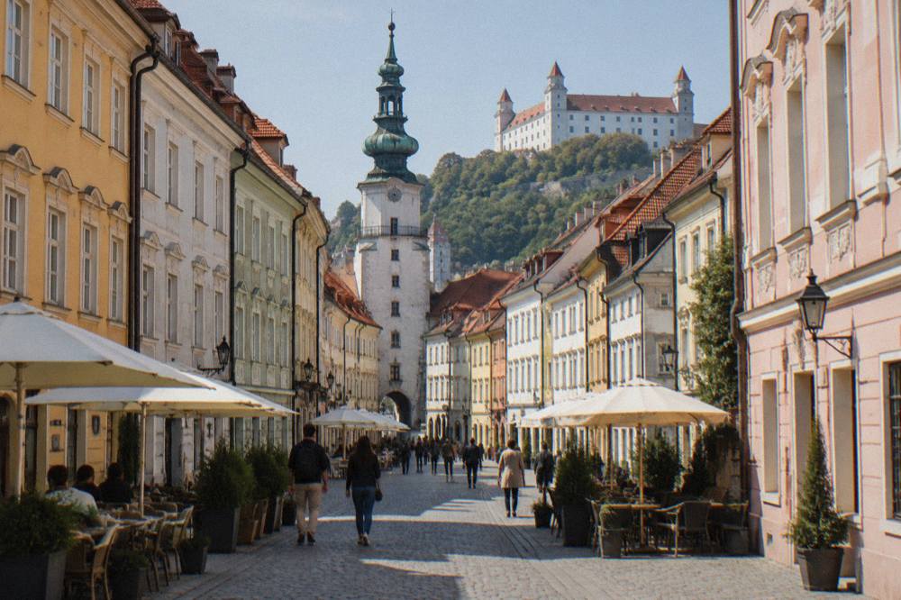 A pedestrian old town street with colourful facades and people strolling
