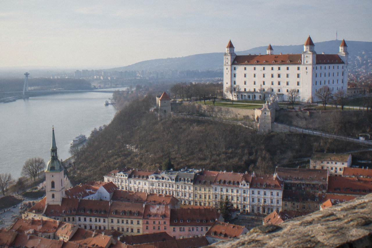 Bratislava Castle standing above the Danube river with the city rooftops below